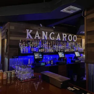a bar with a variety of drinks