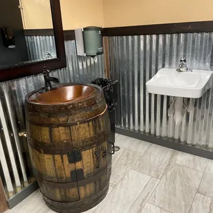 a bathroom with a wooden barrel sink