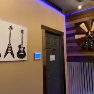 three guitars on the wall of a restaurant