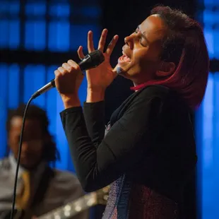 a woman singing into a microphone