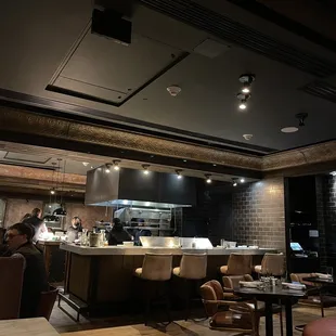 a restaurant with a chef preparing food