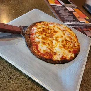 a pizza on a cutting board
