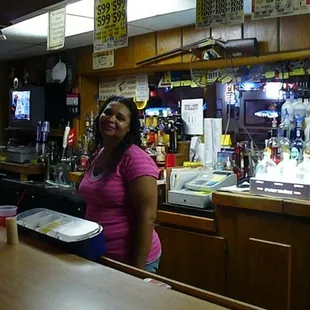 a woman standing at a bar