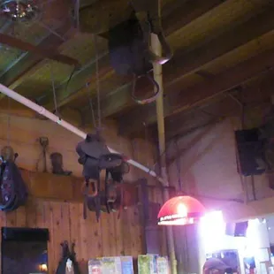 a bar with a lot of items hanging from the ceiling