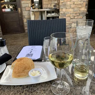 Breaking bread and enjoying some wine is the perfect way to begin a beautiful patio dinner.