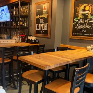 a bar with wooden tables and stools