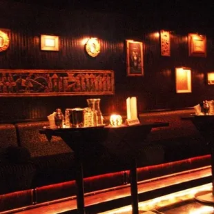 a dimly lit bar with stools