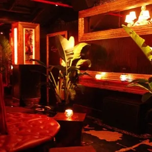 a dimly lit room with a mirror and red lighting