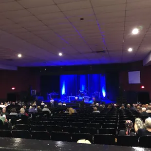 a crowd of people sitting in rows