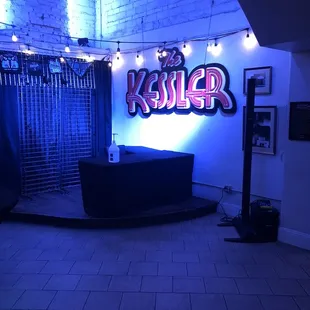 a stage with a neon sign