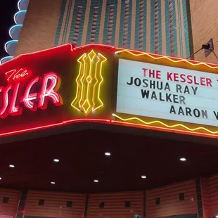 people walking in front of the theater