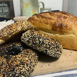 a variety of bagels on a cutting board