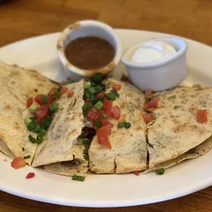 a plate of quesadillas with salsa