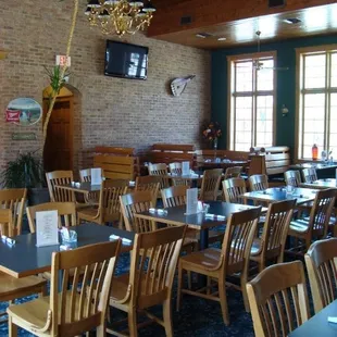 a large dining room with tables and chairs