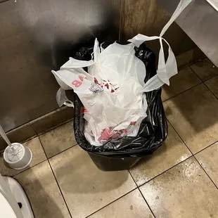  trash can in a public restroom