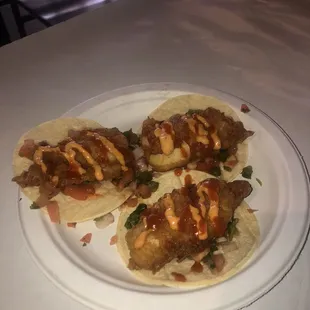 Fried catfish tacos .