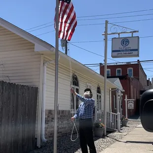 Larry raising our new flag!
