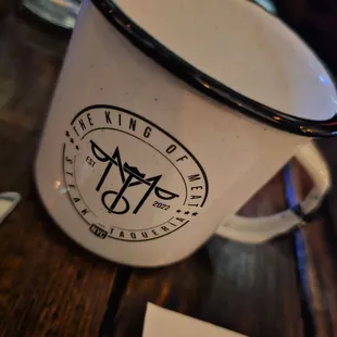 a white coffee mug with a black rim