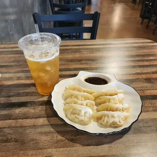 a plate of dumplings and a drink