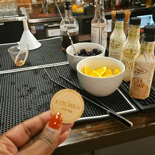 a person holding a cookie in front of a bar
