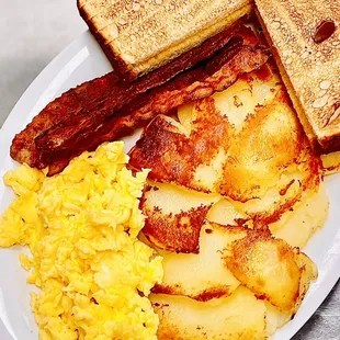 Classic breakfast of champions : Applewood smoked bacon cooked well, scrambled eggs , real home fries &amp; sourdough toast .