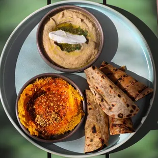 a plate of hummus and pita chips