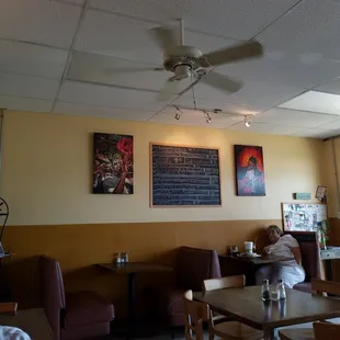a woman sitting at a table in a restaurant