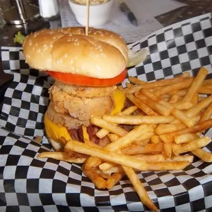 a burger and french fries on a checkered plate
