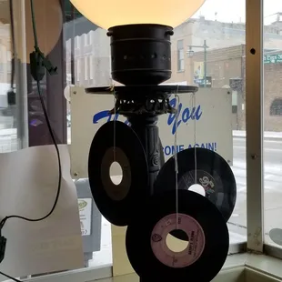 a lamp with vinyl records attached to it