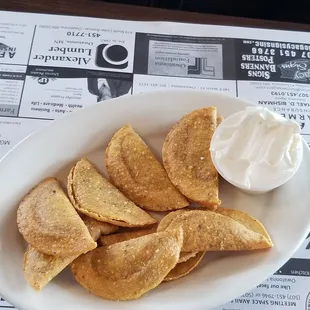 a plate of nachos with sour cream