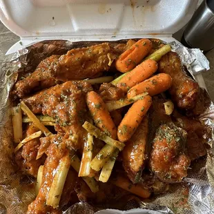 a tray of chicken wings and carrots