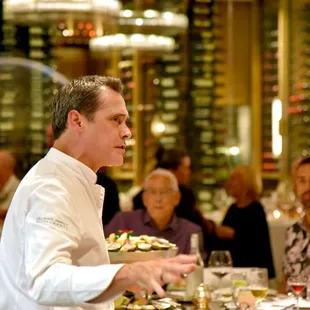 The executive chef and staff present the meal in a lively, theatrical demonstration format.