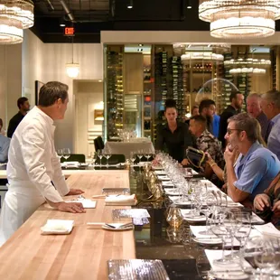 The executive chef and staff present the meal in a lively, theatrical demonstration format.