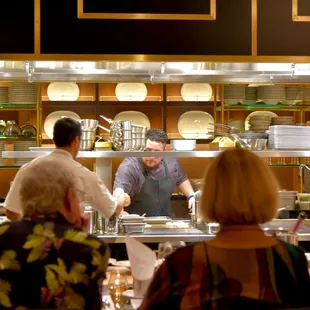 The executive chef and staff present the meal in a lively, theatrical demonstration format.