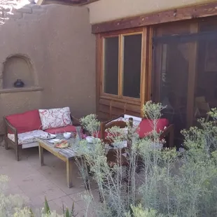 a patio with a table and chairs