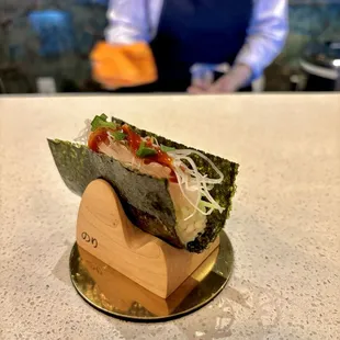 a sushi wrap on a wooden stand