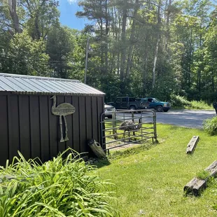 a black shed with a metal roof