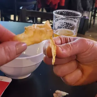 a person holding a piece of food