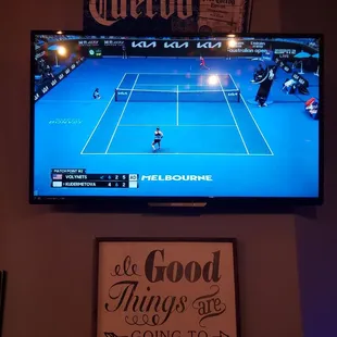 a tennis game being played on a tv