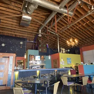 More interior including the bar and hostess stand.