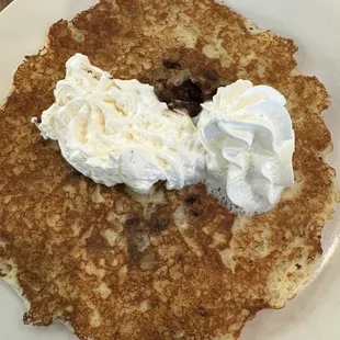 a plate of pancakes with whipped cream