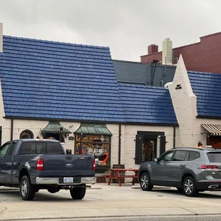 two trucks parked in front of the building