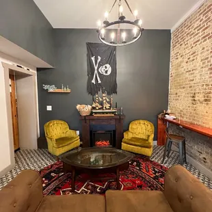 a living room with yellow chairs and a coffee table