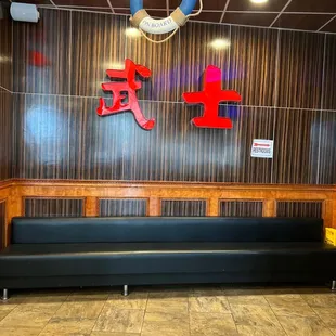 a restaurant with a wooden wall