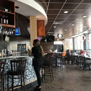 a woman standing at a bar