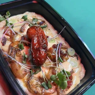 a hand holding a tray of food