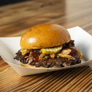 a hamburger with pickles and pickles