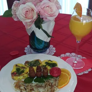a plate of food and a glass of orange juice