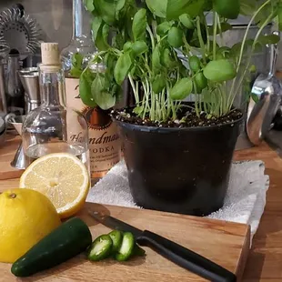 a kitchen counter with a cutting board, knife, lemon, and pepper