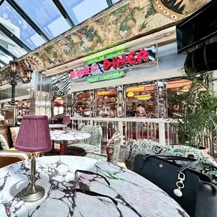 DINER AREA , open 24 /7, and the White tables are from the Bar area .